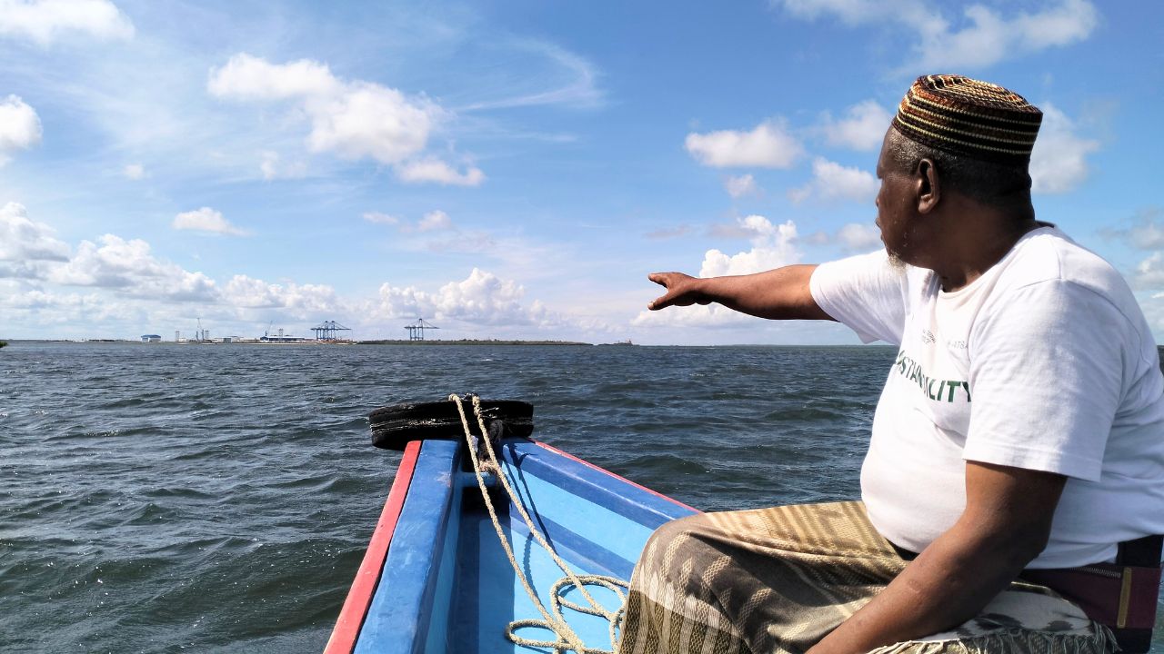 Abubakar Twalib gazing toward port berths from boat