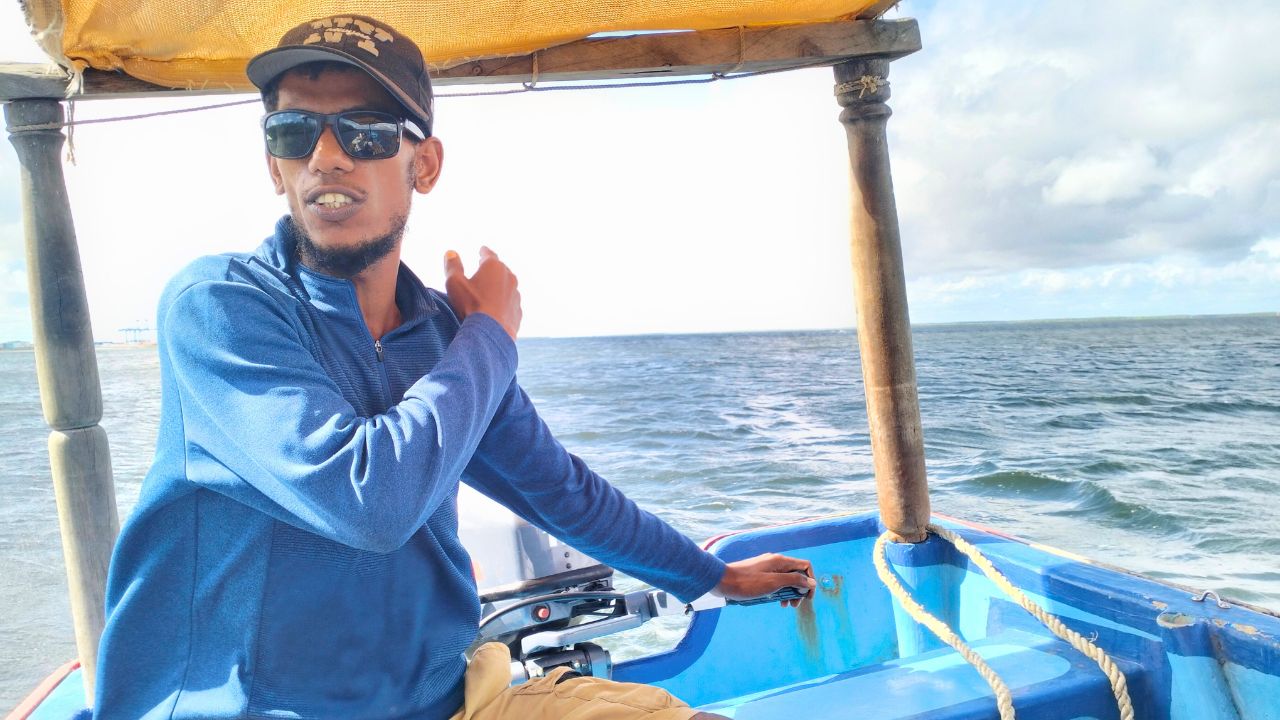 Boat captain Swabir Zein Ahmed piloting a vessel